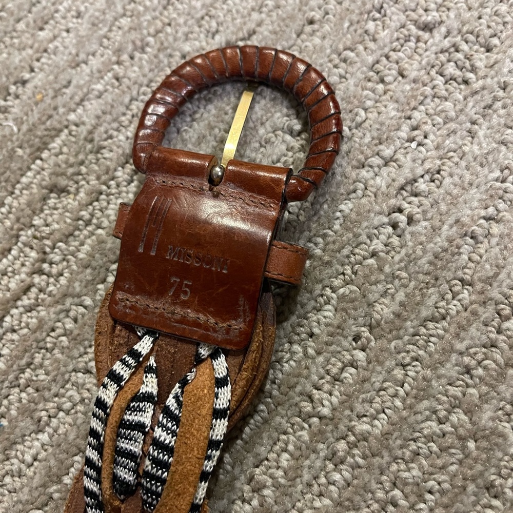 Brown belt with fabric woven through it.